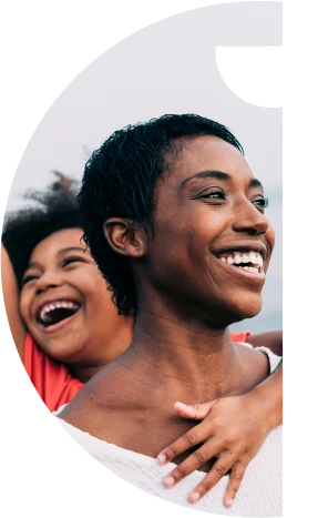 Mãe e filhas sorrindo e olhando para o horizonte